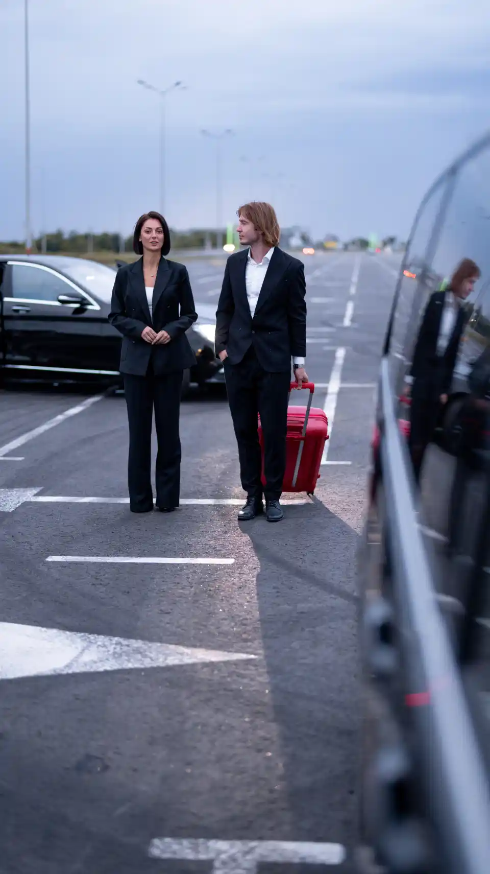 Executive exiting luxury car