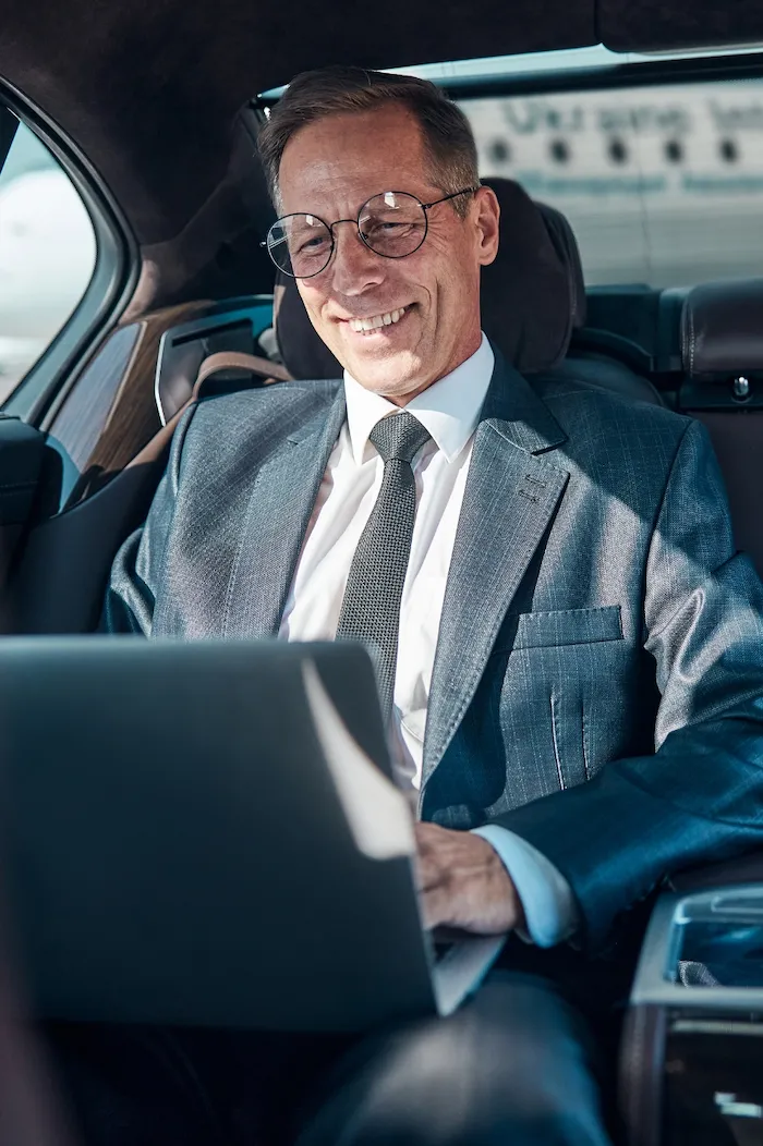 Businessman in Luxury Car at the Airport